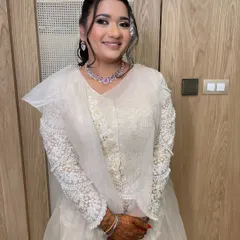 A happy client ready for her sangeet night, with a hairstyle that's both glamorous and comfortable.