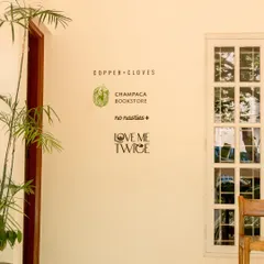 I’ve brought together some of my favorite local and conscious brands right here in the cafe. You can browse thoughtful reads from Champaca Bookstore, find sustainable fashion from No Nasties, or discover treasures at Love Me Twice thrift store. It’s all part of the experience.