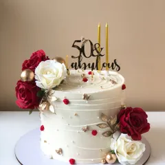 "50 & Fabulous!" This cake celebrates a milestone with style, featuring rich red and white roses and elegant gold accents.