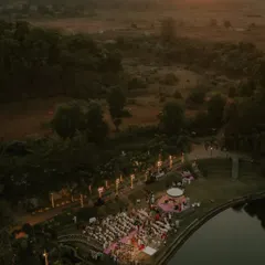 We travel wherever your story takes us. This breathtaking sunset view from a drone captures the grand scale and serene beauty of a destination wedding at Oleander Farms, setting the stage for an unforgettable ceremony by the water.