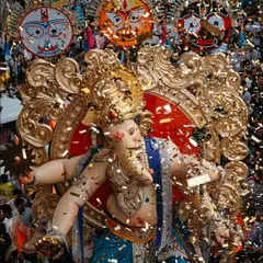 The moment of celebration, with confetti raining down on the Chintamani idol. This shot captures the peak excitement of the Ganesh Chaturthi procession.