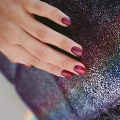 A sophisticated matte red polish, perfect for a chic and confident look.