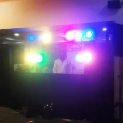 Me behind the console, surrounded by a vibrant array of colorful lights. The right lighting is crucial for setting the mood, and my setup can transform any space into a dynamic dance floor.