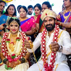 A beautiful portrait of a couple during their traditional wedding ceremony, surrounded by family. We aim to capture the cultural richness and personal joy of such significant events.