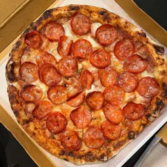 You can never go wrong with a classic Pepperoni pizza. This overhead shot shows a pie generously covered with savory pepperoni, baked to perfection in my wood-fired oven.