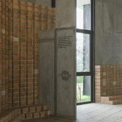 The entrance to 'The Earth' showcases our use of locally sourced CSEB walls flowing seamlessly into granite inlay flooring. This detail highlights our focus on craftsmanship and sustainable, locally-sourced materials.