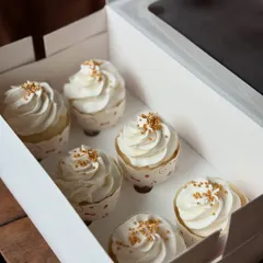 A close up shot showing the fluffy frosting and delicate gold sprinkles on my classic vanilla cupcakes.