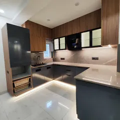 This is a look at a finished modular kitchen, combining sleek grey cabinets with warm wood tones. I focus on creating functional layouts with features like under-cabinet lighting, a tall pantry unit, and durable quartz countertops.