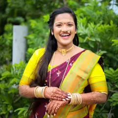 A candid, joyful portrait of a model in a traditional maroon and yellow saree. This shot shows how I capture natural expressions for a lively portfolio.
