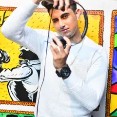 A posed shot against a vibrant, artistic background. My brand is a fusion of creative energy and professional focus, which I pour into every custom remix I make.