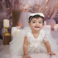 A sweet crawling shot from the same session, capturing her happy expression as she moves.