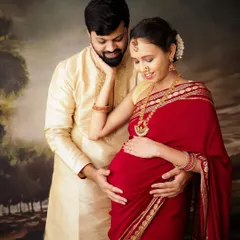 A beautiful portrait of a couple celebrating their pregnancy with a traditional photoshoot. Their ethnic attire and loving embrace make for a truly special memory.