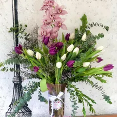 A closer look at one of my favorite stylized vase arrangements. The combination of tall pink orchids, fresh tulips, and fragrant eucalyptus creates a balanced composition that is both modern and elegant.