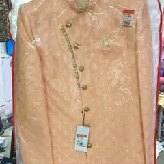 A brand new peach-colored Indo-western sherwani, still in its protective cover. I am constantly updating my collection with the latest designs and colors.