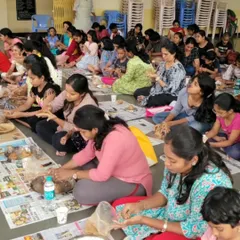 A wide shot of my clay Ganesha workshop, where participants of all ages are deeply engaged in sculpting their idols. It's a mindful and bonding activity for the whole family.
