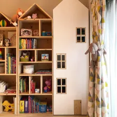 These house-shaped bookshelves are one of my signature designs. They turn book storage into a playful display, encouraging kids to pick up a story. This unit is made from natural pine wood.