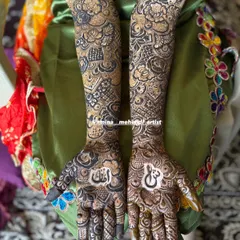 This design features a beautiful mix of bold floral work on the forearms and intricate, detailed patterns on the palms and fingers, finished with classic dark tips.