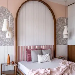 A custom-built arched headboard featuring white vertical panels. This residential project shows how I can integrate fluted designs into specific architectural features for a cohesive look.