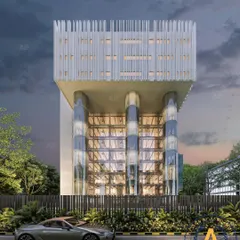 A frontal view of Joy Tower, Noida, where a modern commercial facade is defined by its elevated structure and glass-encased columns. The design is a bold statement of innovation and contemporary architecture.