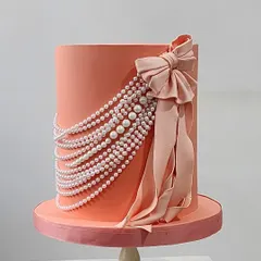 A classic design with a modern twist. This beautiful cake features a cascade of edible pearls and a perfectly sculpted fondant bow, a technique we cover in our fondant essentials workshop.