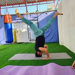 The headstand, or Sirsasana, is called the king of all asanas. It looks hard, but I teach it step by step. This variation with split legs helps open the hips while building core and shoulder strength.