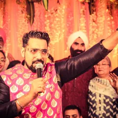 Mic in hand, ready to get the party started. This was at a vibrant sangeet ceremony where the energy was infectious. I love being in the middle of the crowd, feeling the excitement.