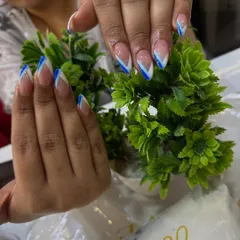 A modern V-shaped French tip using a bold blue color. This is a great way to add a pop of color while keeping the classic French feel.