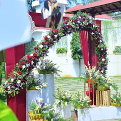 Another look at the beautiful floral photo arch at a sunny outdoor wedding.