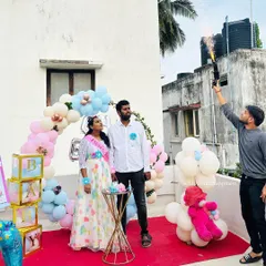 The parents-to-be enjoying the gender reveal moment during their surprise baby shower on the terrace.