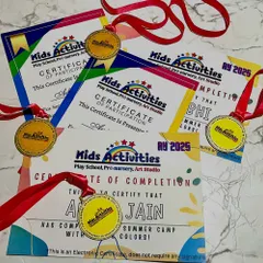 A proud moment for our lovely kiddos. This image shows the certificates of participation and completion, along with medals, that we award to our students. We love celebrating every achievement, big or small, to build their confidence and recognize their hard work.