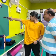 Our head coach, Manjunath Patagar, provides one-on-one guidance to a shooter. This focused training helped her set a new record and win two gold medals at the South Zone Shooting Competition.