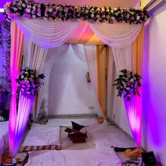 For an indoor wedding ceremony, we created this beautiful mandap with draped fabrics and floral accents. The intimate setup is perfect for a home wedding or a smaller banquet hall, ensuring a traditional and serene atmosphere.