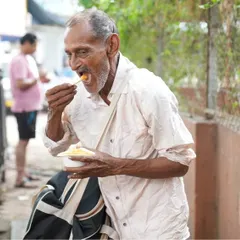 An elderly man enjoying a wholesome meal. Our aim is to create a kinder, healthier world, one meal at a time.