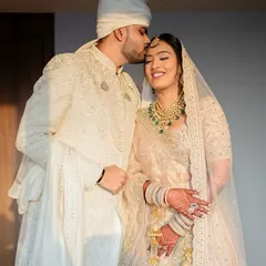 The elegance of an ivory lehenga is timeless. This look is all about soft, romantic beauty, capturing a moment of pure joy and grace for the bride and groom. 🤍