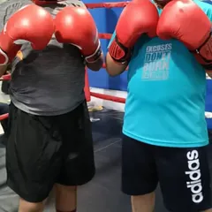 Our young champions are always preparing for the next challenge. Here, two of our junior members pose in the ring, ready for their training session focused on cardio, conditioning, and competition prep.