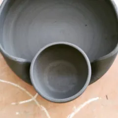 A work-in-progress shot of a chip 'n' dip serving bowl before its first firing. This popular design features a large bowl for chips with a smaller, attached bowl for dip, all in one seamless piece.