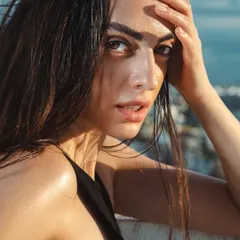 I love creating edgy, high-fashion looks for editorial shoots. This wet-look hair and glossy skin combination was achieved using specific products to give a fresh, out-of-the-ocean feel that holds up under direct sunlight for outdoor photography.