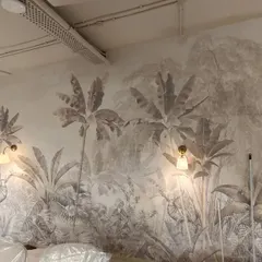 Here you can see my team member precisely installing a large-scale botanical mural in a commercial space. This sepia-toned jungle theme brings a sense of calm and nature into the work environment.