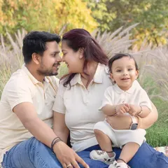 A sweet, romantic moment between parents while their son smiles for the camera. Outdoor sessions allow for a beautiful mix of candid and posed shots.