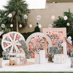 We brought a soft, pastel jungle to life for a little one's first birthday. This wide view showcases the complete themed environment, featuring gentle animal props, custom backdrops, and dreamy balloon installations for a magical celebration.