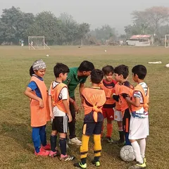 Our U8 team in a pre-match huddle, learning the importance of strategy and teamwork.