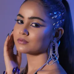 Explore your creative potential with high-fashion and editorial styling. This look, featuring a sleek high ponytail with metallic accents and sharp graphic eyeliner, represents the advanced, trend-setting techniques taught in our workshops.