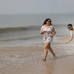 Capturing the fun and spontaneous moments is key to our candid style. Here, a couple playfully runs along the shoreline, resulting in a natural photograph filled with laughter and movement.