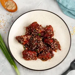 A plate of our saucy Sesame Chicken, a perfect balance of sweet and savoury flavours with a rich coating on every piece.
