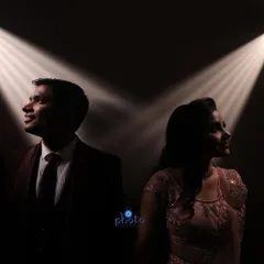 A dramatic engagement portrait using spotlights to create a cinematic effect. This technique highlights the couple while keeping the background dark, adding a touch of glamour.