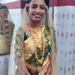 A classic South Indian muhurtham look for a beautiful bride. The cream and green Kanjivaram saree is draped traditionally, ensuring the pleats fall perfectly and the bride is comfortable throughout the long ceremony.
