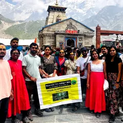 Our group at the Kedarnath temple, holding our banner with pride. We successfully complete multiple batches for this spiritual yatra every year.