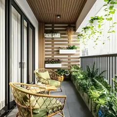 This long balcony was transformed into a green haven with a variety of plants in wall-mounted and floor planters. The wicker seating provides a comfortable spot to enjoy a cup of coffee surrounded by nature.