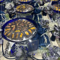 My Azure Crystal Bowl Hampers, arranged for a grand event. The deep blue crystal bowls filled with gourmet dates and paired with velvet potlis create a stunning visual and a luxurious guest gift.