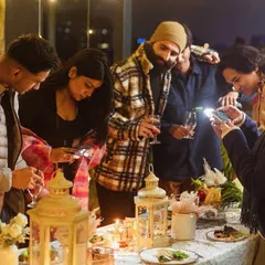 My goal is to create moments so beautiful you have to capture them. Here, guests are gathered around the dinner table, taking photos of the food and decor, fully immersed in the experience.
